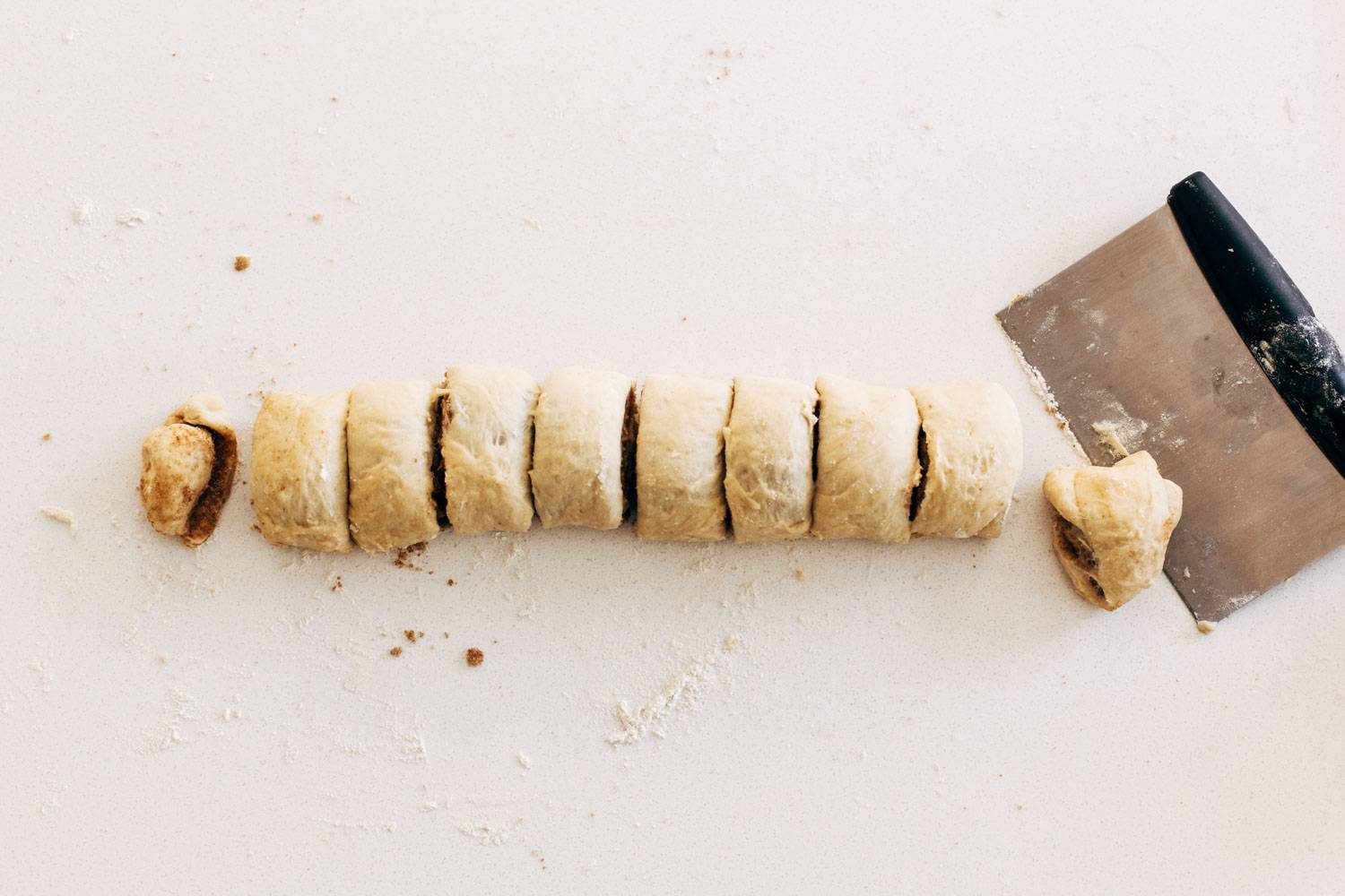 Cinnamon roll dough rolled up and cut into sections.