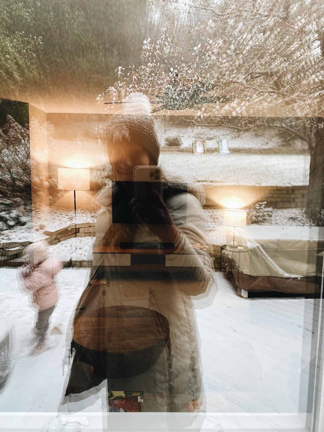 Lindsay with kids on the back patio with snow.