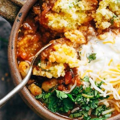 Spicy Posole in soup mug with cornbread.