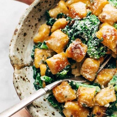 Sweet Potato Gnocchi in bowl with broccoli rabe.